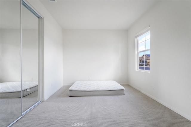 carpeted bedroom featuring a closet