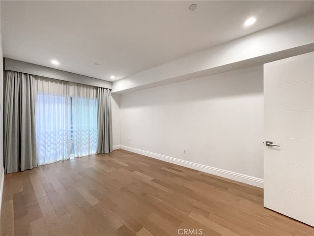 empty room with wood-type flooring