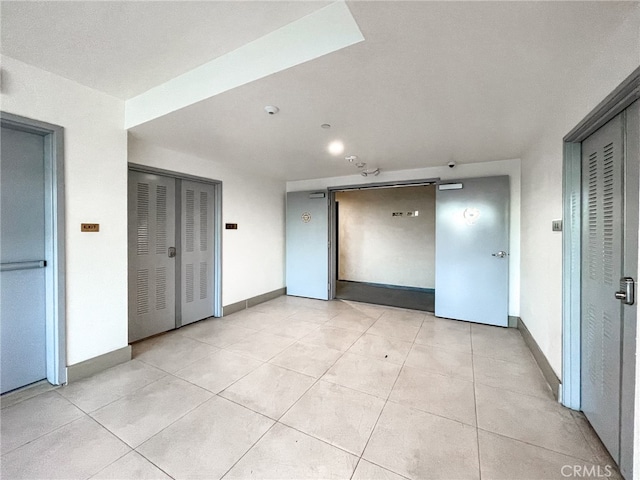 spare room with light tile patterned floors