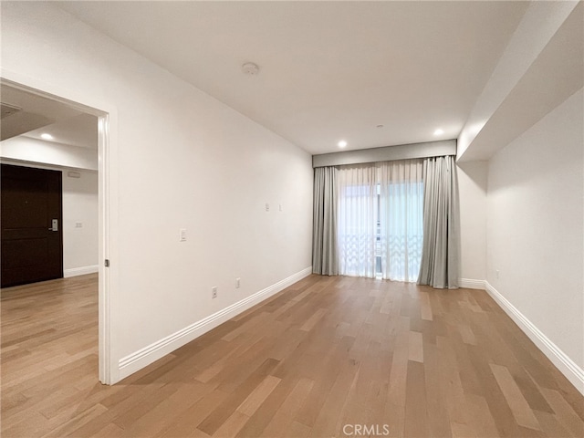 spare room featuring light wood-type flooring