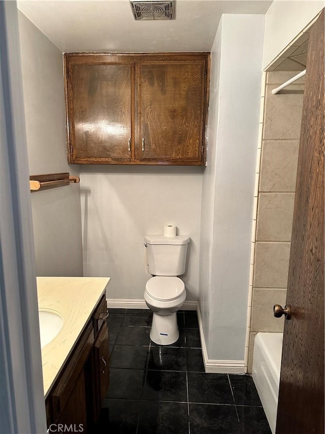 bathroom featuring tile patterned flooring, vanity, and toilet