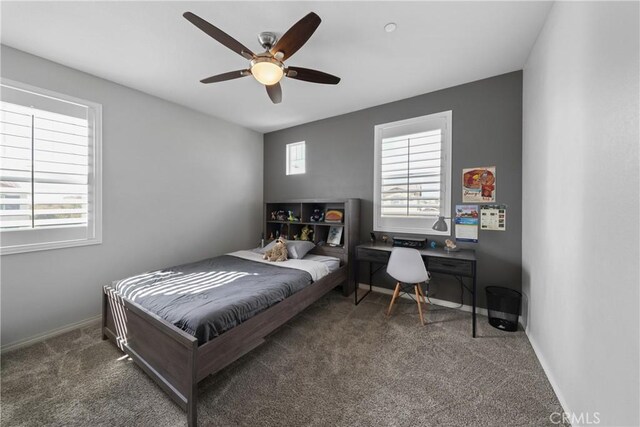 bedroom featuring dark carpet and ceiling fan