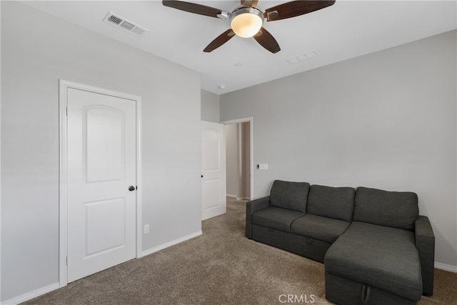 carpeted living room with ceiling fan