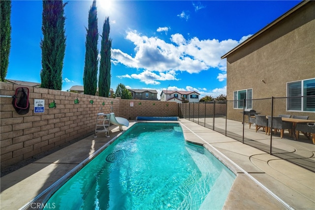 view of swimming pool with a patio