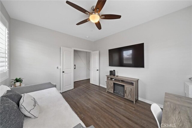 bedroom with ceiling fan and dark hardwood / wood-style flooring