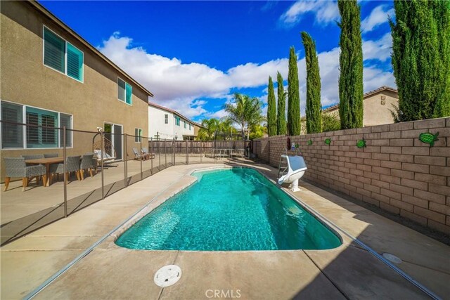 view of swimming pool with a patio