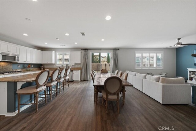 dining area featuring ceiling fan and dark hardwood / wood-style flooring