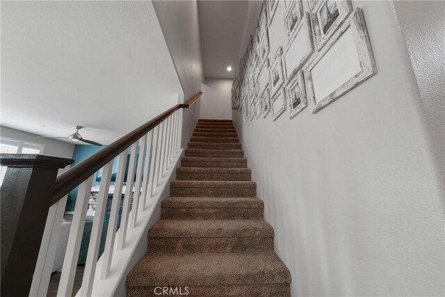 stairway with ceiling fan