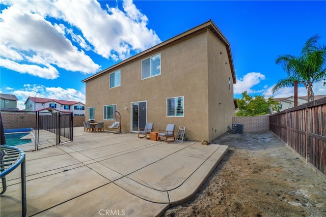 back of house with central AC and a patio