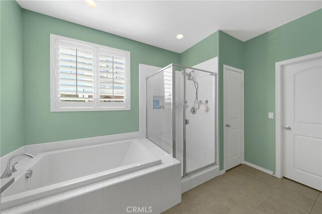 bathroom featuring tile patterned floors and independent shower and bath