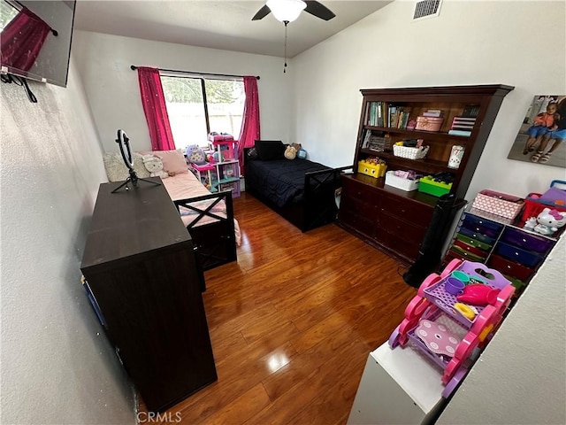 bedroom featuring ceiling fan and dark wood-type flooring