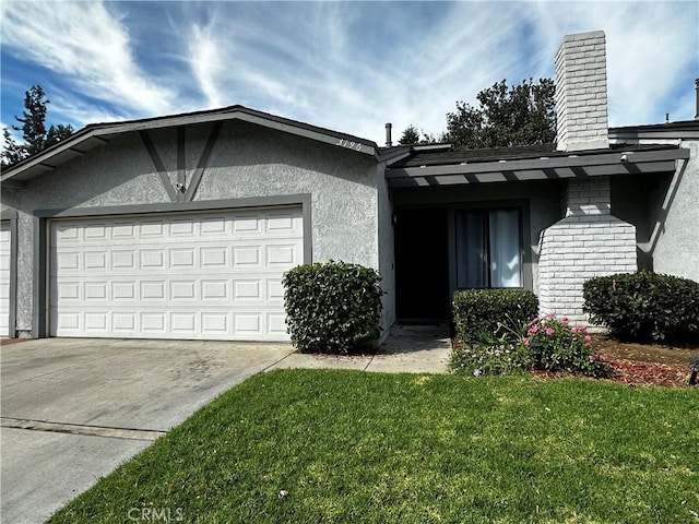 view of front of property with a front yard and a garage