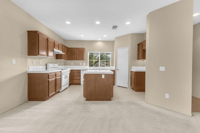 kitchen with a center island, light carpet, and white appliances