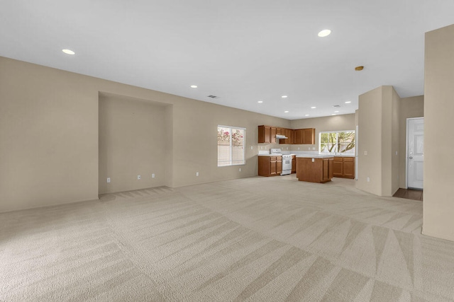 unfurnished living room with light carpet