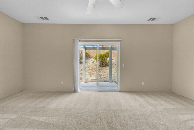 carpeted spare room with ceiling fan