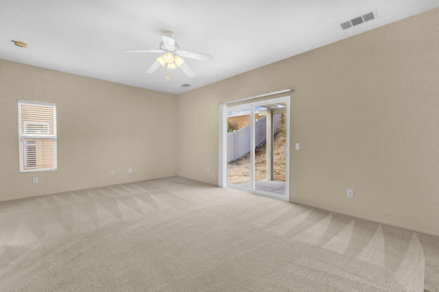 empty room featuring light colored carpet and ceiling fan