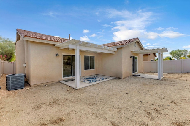 rear view of house featuring a pergola, a patio area, and central air condition unit