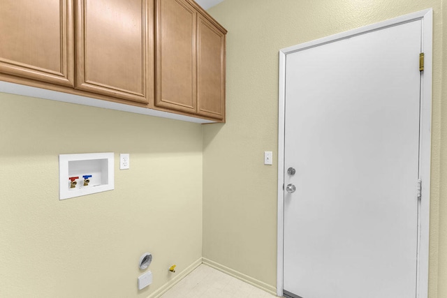 clothes washing area with hookup for a gas dryer, washer hookup, and cabinets