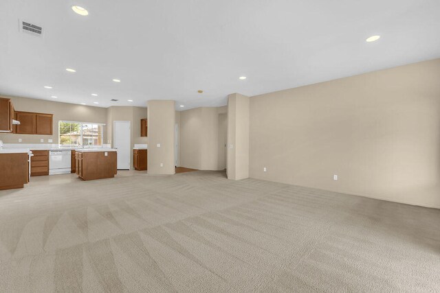 unfurnished living room with light colored carpet