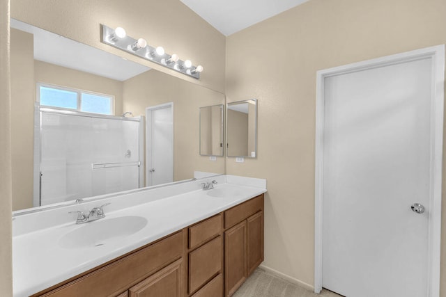 bathroom featuring vanity and an enclosed shower