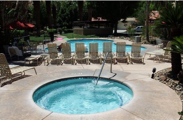 view of pool with a community hot tub and a patio