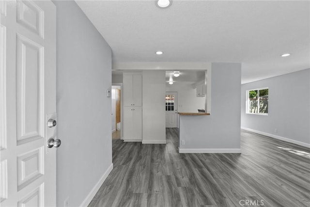 unfurnished living room with dark hardwood / wood-style flooring