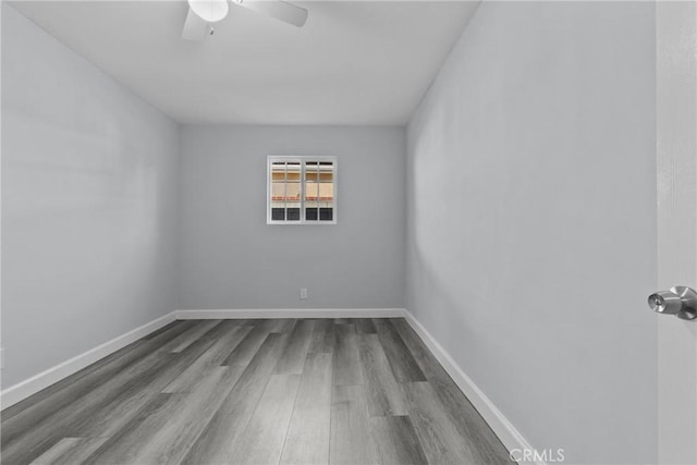 spare room featuring ceiling fan and hardwood / wood-style flooring