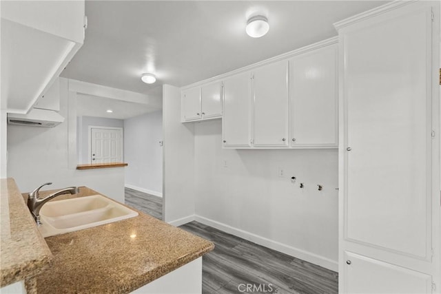 kitchen with stone counters, sink, white cabinets, and dark wood-type flooring