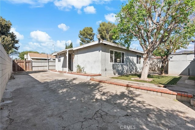 rear view of property featuring a patio area