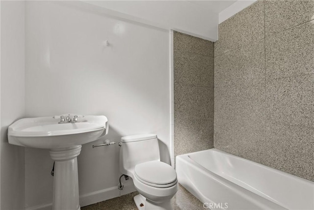 bathroom featuring sink, toilet, and a bath