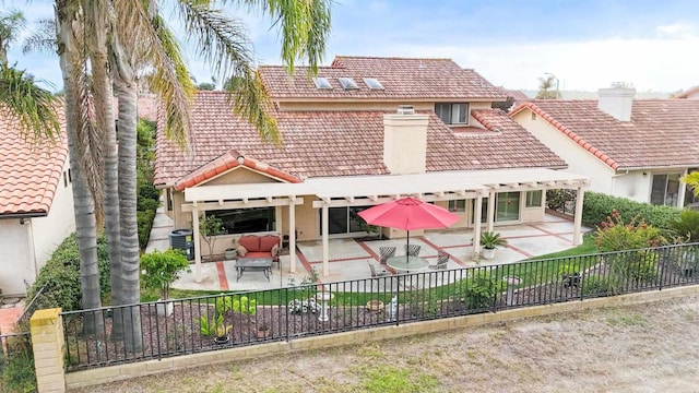 rear view of property featuring a patio area