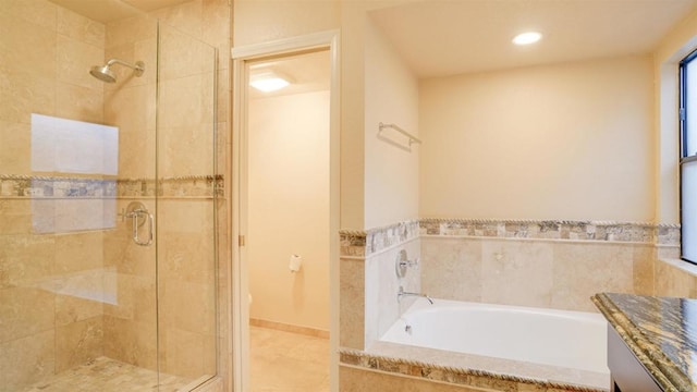 bathroom featuring shower with separate bathtub