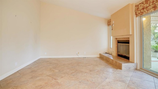 unfurnished living room featuring a tile fireplace