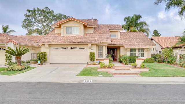 mediterranean / spanish-style house featuring a garage and a front lawn