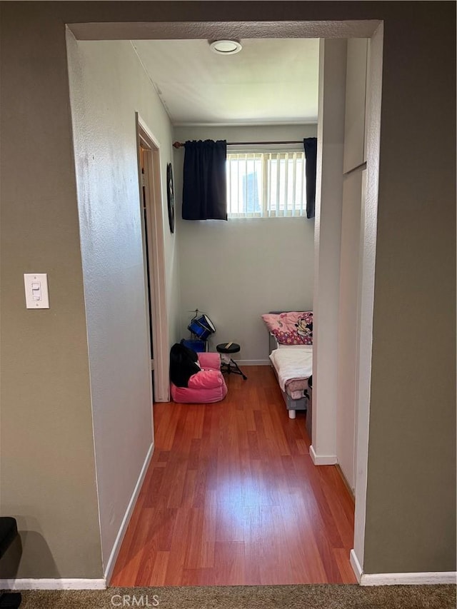 hallway with hardwood / wood-style floors