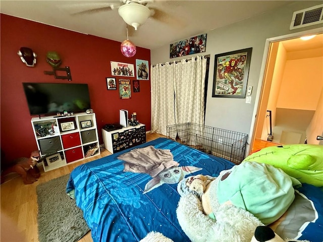 bedroom with hardwood / wood-style flooring and ceiling fan