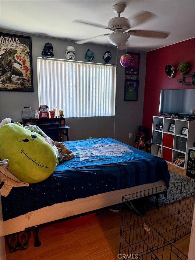 bedroom with hardwood / wood-style flooring and ceiling fan