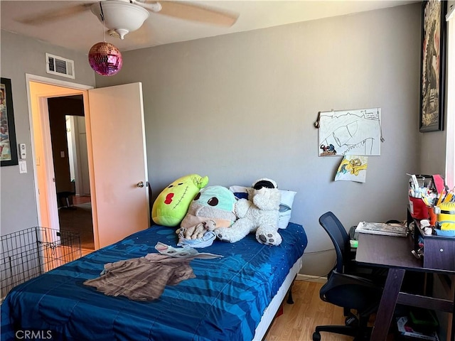 bedroom with wood-type flooring and ceiling fan