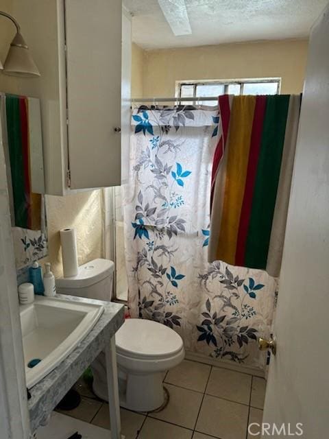 bathroom featuring sink, tile patterned flooring, a textured ceiling, toilet, and a shower with shower curtain