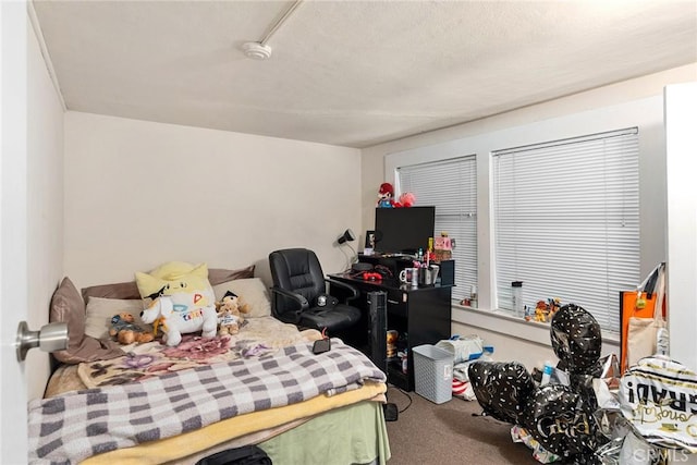 bedroom featuring carpet flooring and a textured ceiling