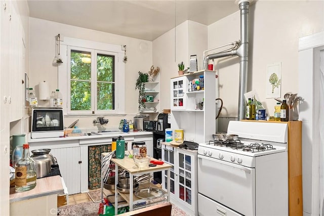 kitchen with white cabinetry and white gas range