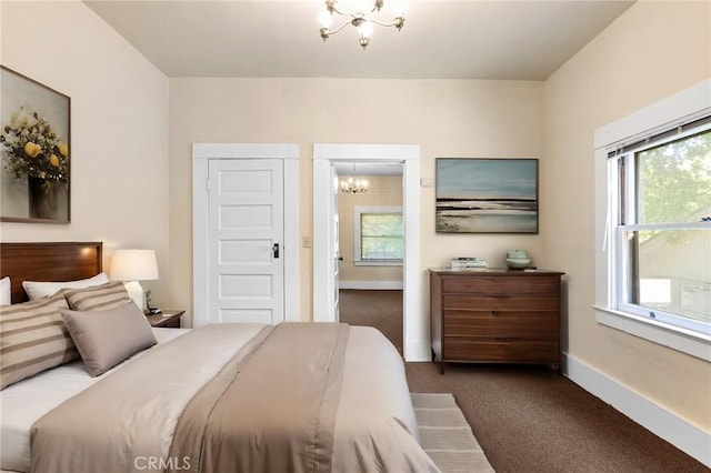 carpeted bedroom featuring a chandelier