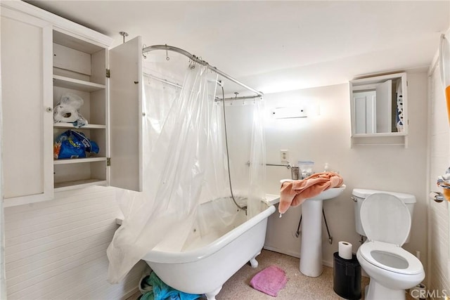 bathroom featuring shower / bath combination with curtain and toilet