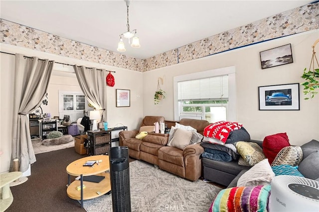 living room featuring a notable chandelier and light colored carpet