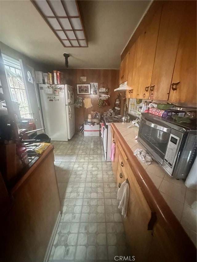 kitchen featuring tile countertops and appliances with stainless steel finishes