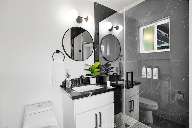 bathroom with a shower with shower door, toilet, and vanity