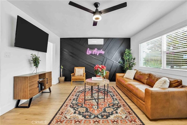 living room featuring light wood-type flooring and ceiling fan