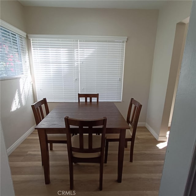 dining space with hardwood / wood-style floors