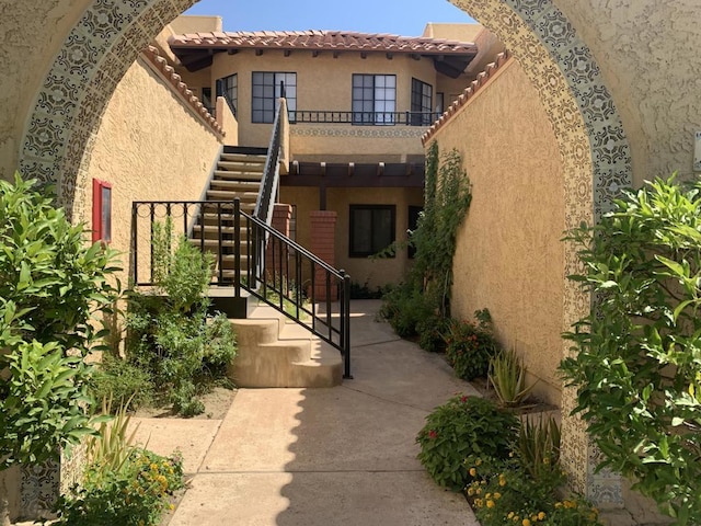 view of exterior entry featuring a balcony