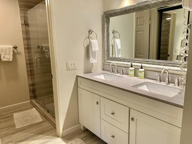 bathroom featuring vanity, a shower with shower door, and hardwood / wood-style flooring